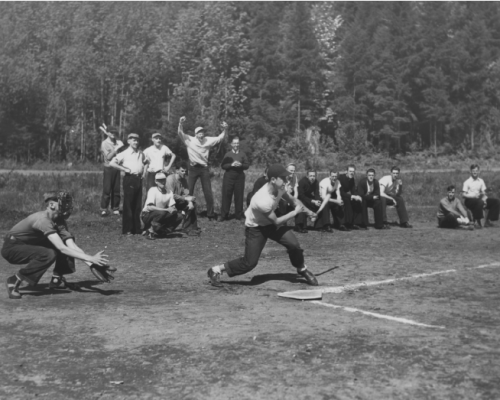A Group Of People Playing Baseball On A Field