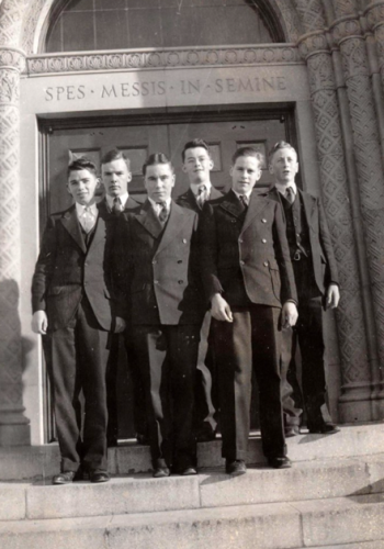 A Group Of People Posing For A Photo In Front Of A Building